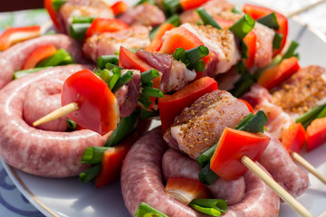 Close up pf delicious chicken breast on wooden skew with fresh vegetables, garlic, paprika fried on mangal barbeque grill and smoke