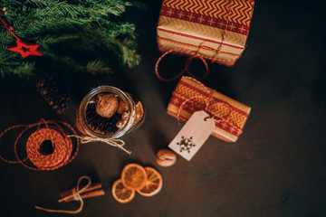 Christmas gift with homemade gingerbread cookies, nuts and chocolates. Glass jar, fir branches, Christmas spices and decor. Winter holidays, New Year or Christmas concept. Top view with copy space.