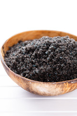 Sea salt in bowl, aroma oil in bottles, Wellness and flowers on grey textured background and...