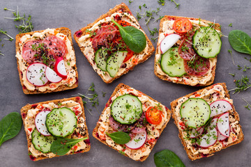 Sandwiches with cream cheese, vegetables and salami.
