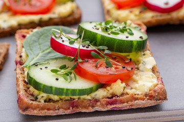Sandwiches with cream cheese, vegetables and salami.