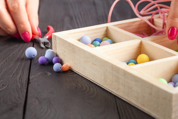 Working process. Handcraft concept. Creative woman making beautiful beads of colorful balls