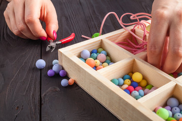 Jewelry making and beading process.Colored beads.Beaded jewelry