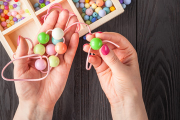 Woman making jewelry at home