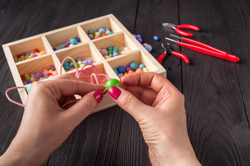 Working process. Handcraft concept. Creative woman making beautiful beads of colorful balls