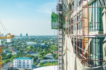 Construction site background. Hoisting cranes and new multi-storey buildings.