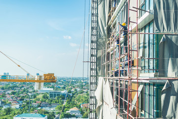 Fototapeta na wymiar Construction site background. Hoisting cranes and new multi-storey buildings.