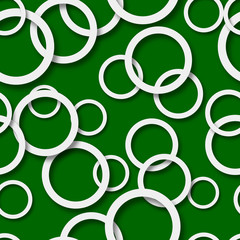 Abstract seamless pattern of randomly arranged white rings with soft shadows on green background