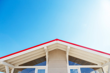 Frame house facade with colorfull roof