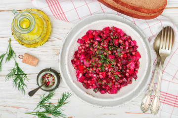 Vinaigrette is a traditional Russian and Ukrainian vegetable salad of beets, carrots, potatoes, pickles, green peas and dill. Vegetarian diet dish. Selective focus
