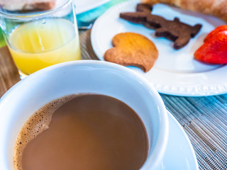 healthy Italian breakfast, on the farm, with coffee and cow's milk, homemade juice and biscuits, croissant and tasty strawberries