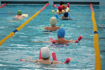 group of older women doing water aerobics in the pool