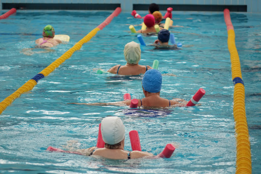 Group Of Older Women Doing Water Aerobics In The Pool