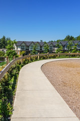 Obraz premium Convenient concrete walkway along the row of new townhouses