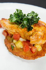 Roasted chicken breast served with potato pancake, pineapple, Italian cheese and cherry tomatoes