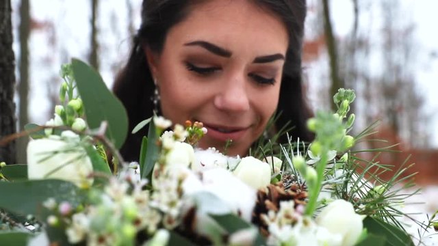 View of bride and her eyes holding wedding bouquet captured in slow motion.