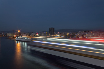 light trail of ship inside the harbor long exposure