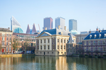 Fototapeta na wymiar View of the Hofvijver / Court Pond adjoined by museum Mauritshuis and the Binnenhof (Inner court) housing the States General and the Prime Minister of The Netherlands in The Hague, The Netherlands. 
