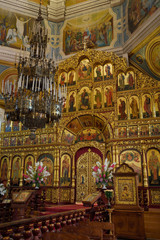 Fototapeta na wymiar Interior of Ascension Cathedral in Almaty Kazakhstan with gold leaf iconostasis wall to the sanctuary