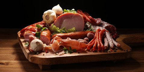 Variety of meat products including ham and sausages.