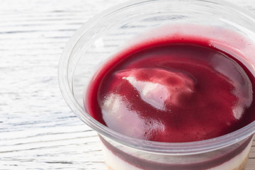 Tiramisu with blueberry mousse in a plastic jar.