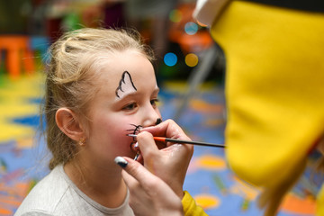 The animator paints the face of the child