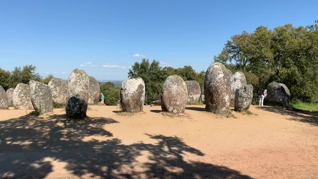Almendres Cromlech megalithic stone formation in Portugal on a blue sky day with copy space