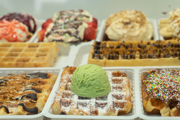 Traditional Belgian dessert - waffle with icecream and cream on the store shelves in Brussels