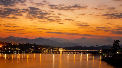 Naklejka premium Travel asia. Panoramic view of Golden morning light. Mon Bridge is the long wooden bridge. Official name is Attanusorn Bridge. Is the route to Mon village, Sangkhla Buri, Kanchanaburi, Thailand.