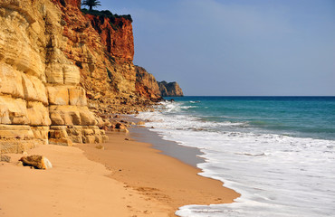 Fototapeta na wymiar Cliffs on the sand beach of Algarve