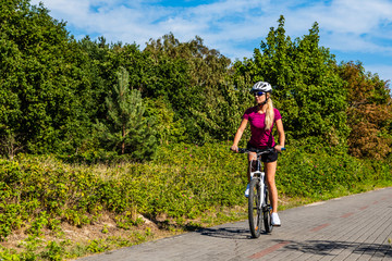 Naklejka premium Young woman cycling