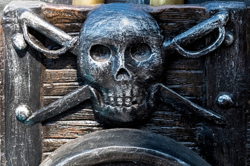 Pirate emblem on the gun carriage of an ancient cannon.