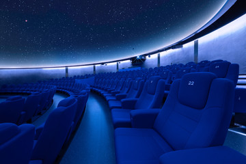 A breathtaking star projection at the planetarium with comfortable seats - obrazy, fototapety, plakaty