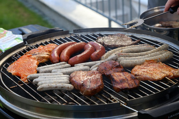 Meat and sausages are fried on the grill