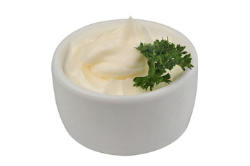 Mayonnaise and parsley in a bowl on an isolated white background