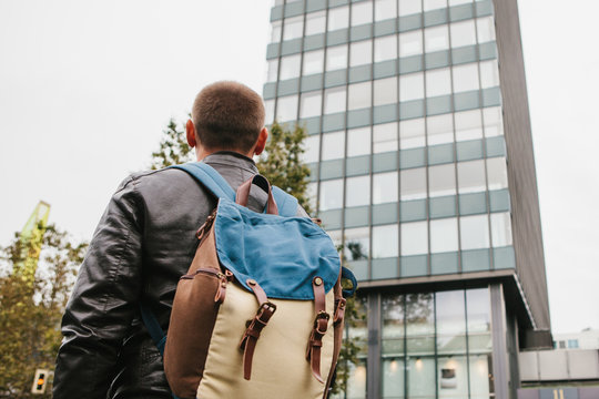 A tourist with a backpack or a guy arrived to check into apartments or watch sights in a big city or get lost in an unfamiliar place.