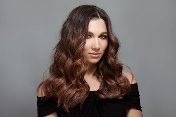 Fototapeta premium Beautiful woman with long brown curly hair.