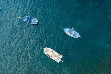 Fototapeta premium Three motor boats are anchored in the ocean shelf. The view from the top. Copy space.