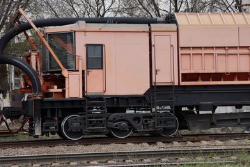 pink cabin repair locomotive stands on the railroad