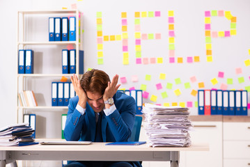 Young employee suffering from excessive work  