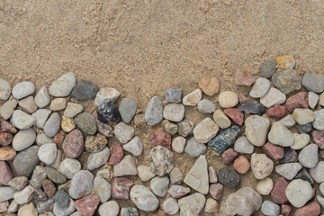 Fototapeta na wymiar border made of pebble stones on sand
