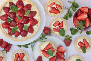 Tart with strawberries and whipped cream decorated with mint leaves
