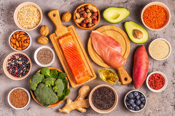 Superfoods on gray concrete background. Top view.