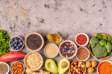 Superfoods on gray concrete background. Top view.