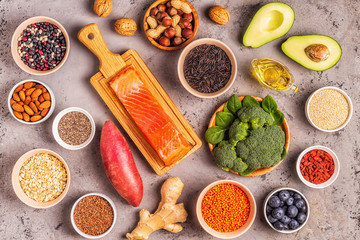 Superfoods on gray concrete background. Top view.