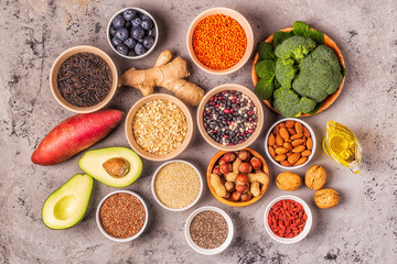 Superfoods on gray concrete background. Top view.