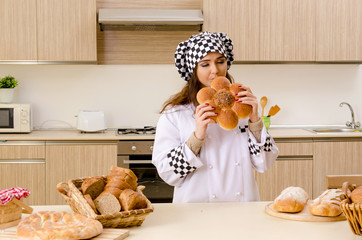 Young female baker working in kitchen 