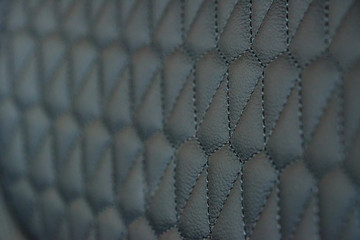 Perforated leather seat texture in modern car close