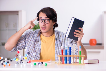 Young student physicist preparing for exam at home    