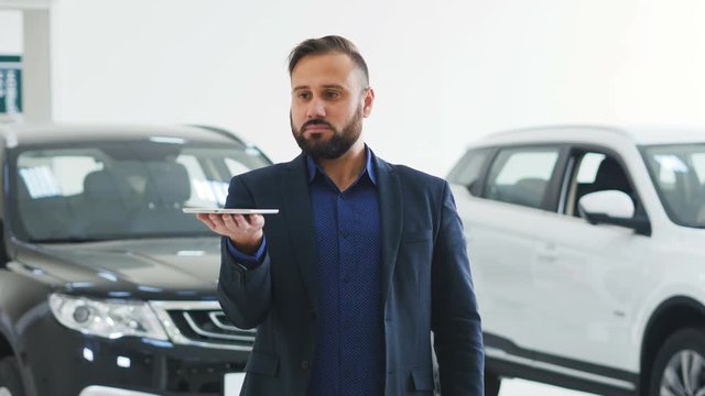 Image for graphic implements. Man in business suit in the showroom with future technology screen